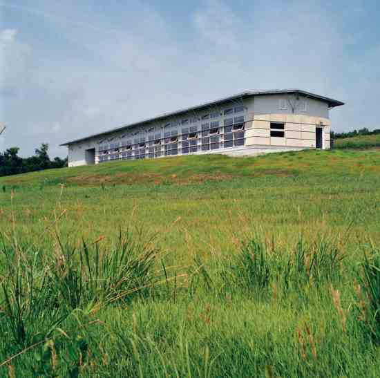 
This Kansas prairie home includes operable windows set high on the north side for natural ventilation. Southern windows are protected from hot summer sun by continuous louvers. A sod roof helps insulate.
